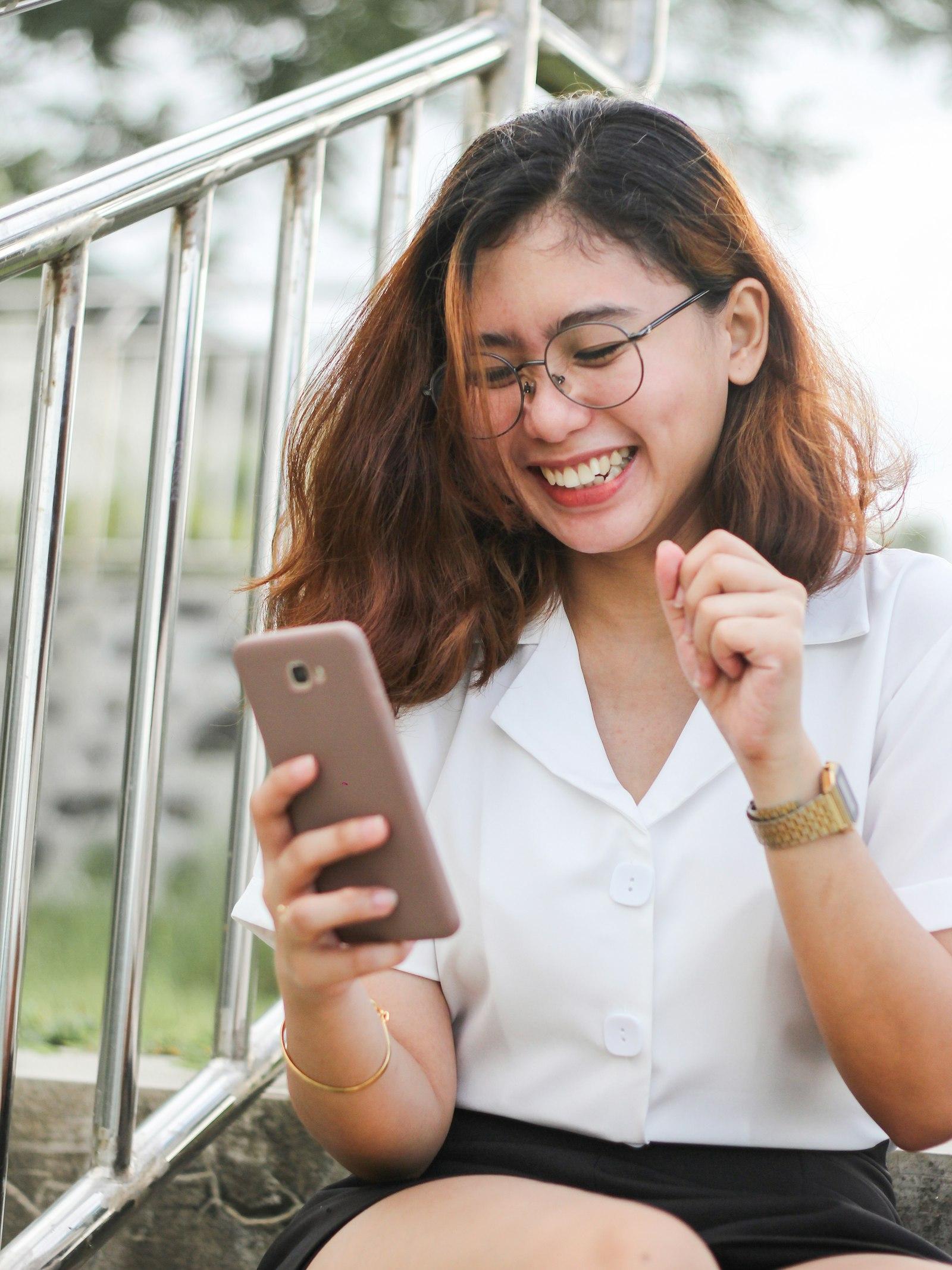 A TrueLend customer checking her loan details on her phone